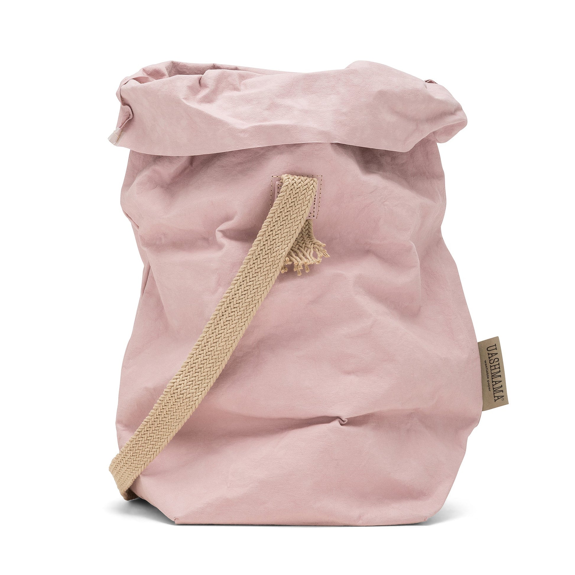 A dusky pink washable paper bag with a single cotton carry strap in a natural tone. The top is displayed open and rolled down, with a natural toned UASHMAMA logo tab on the right hand side.