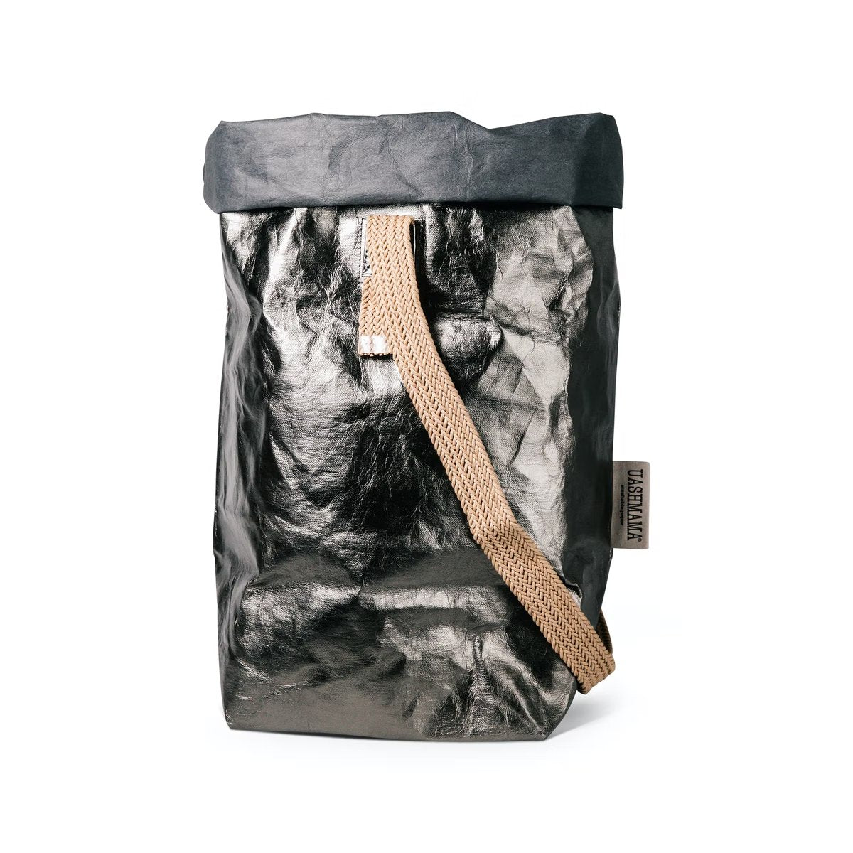 A pewter metallic washable paper bag with a single cotton carry strap in a natural tone. The top is displayed open and rolled down, with a natural toned UASHMAMA logo tab on the right hand side.