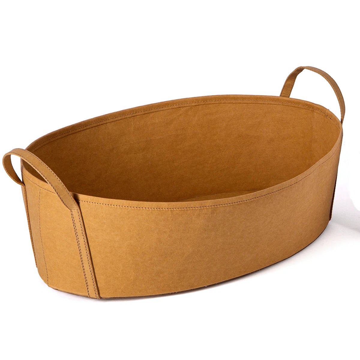 A tan washable paper storage basket is shown from a 3/4 angle, with a handle at each side.