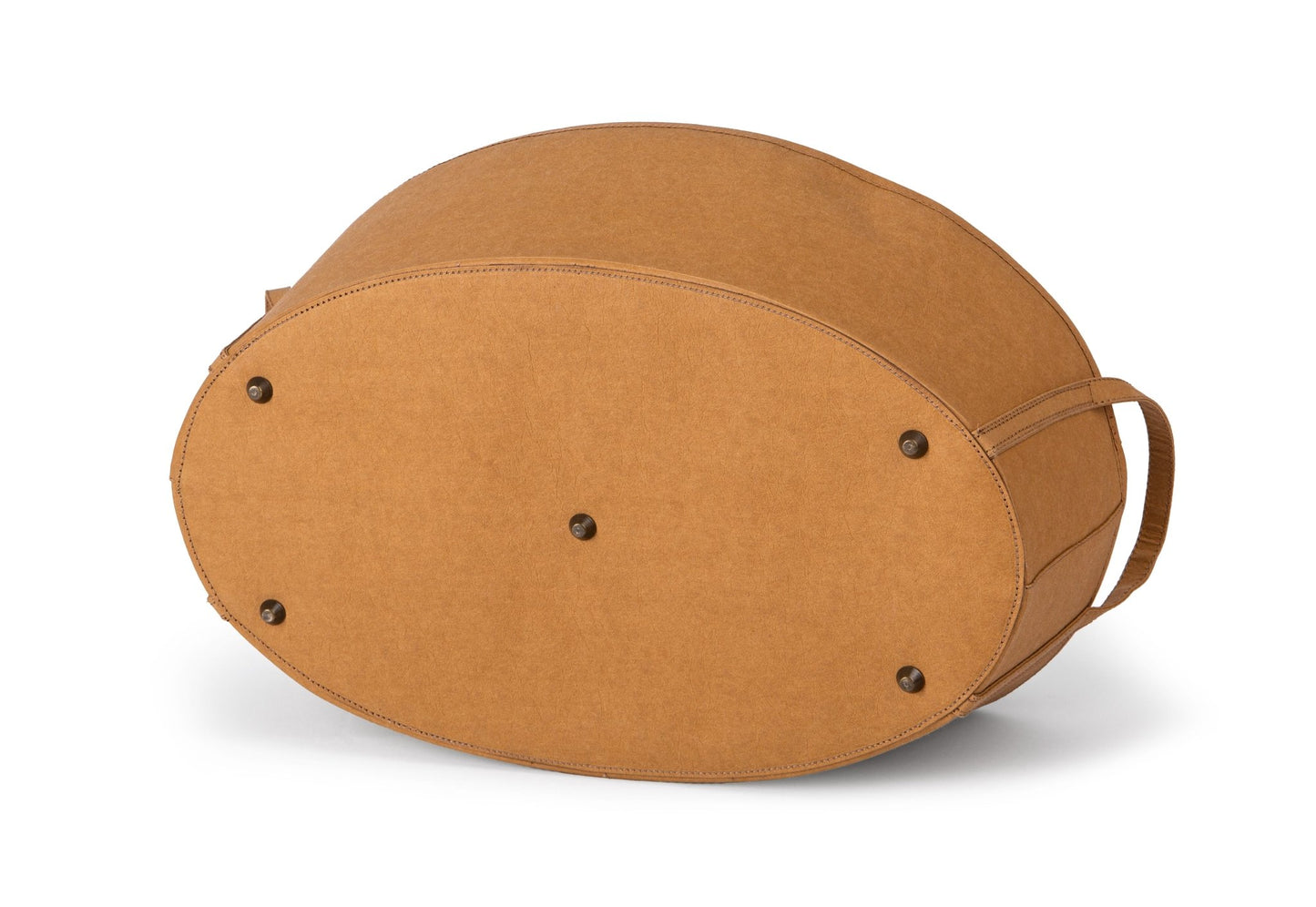 A rounded oblong storage box in tan coloured washable paper is shown from the bottom angle. it features two side handles and metal studs on the bottom for protection from surfaces.