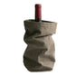 A bottle of red wine is shown inside a mid grey washable paper wine holder.