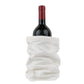 A bottle of red wine is shown inside a white washable paper wine holder.