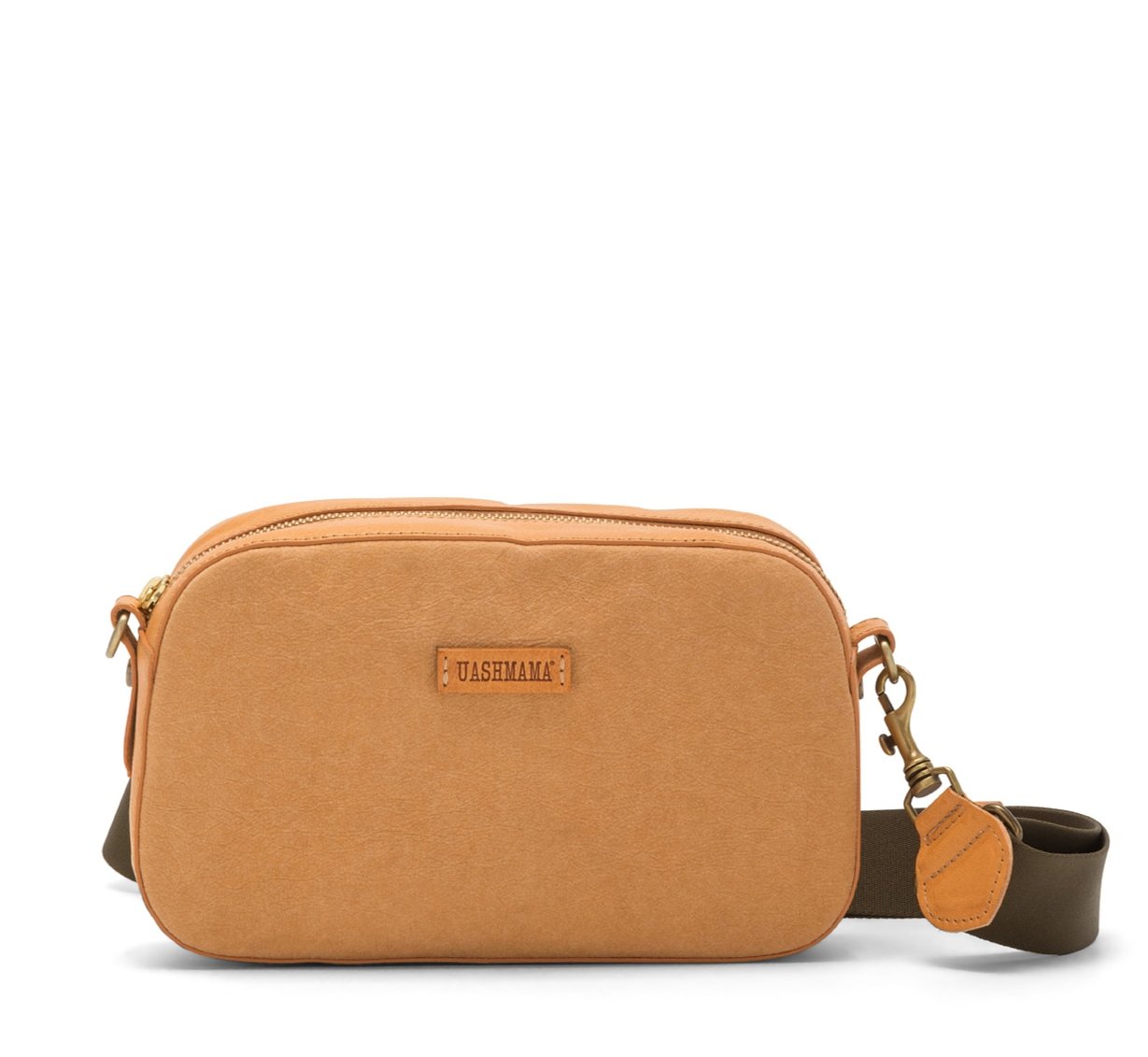 A washable paper cross-body bag is shown with a front tab bearing the UASHMAMA logo in a small font. The bag is shown in tan, with a khaki cotton strap with antique brass hardware.
