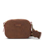 A small washable paper cross-body bag is shown with a front tab bearing the UASHMAMA logo in a small font. The bag is shown in chocolate brown, with a brown cotton strap with antique brass hardware.