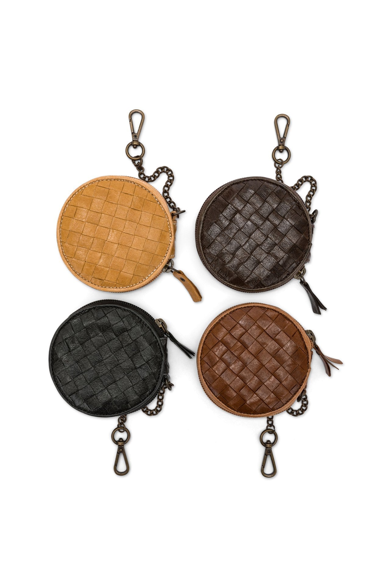 A set of four round washable paper woven round coin purses are shown together in a square on a white background. Clockwise from top left they are tan, chocolate brown, mid brown and black. 
