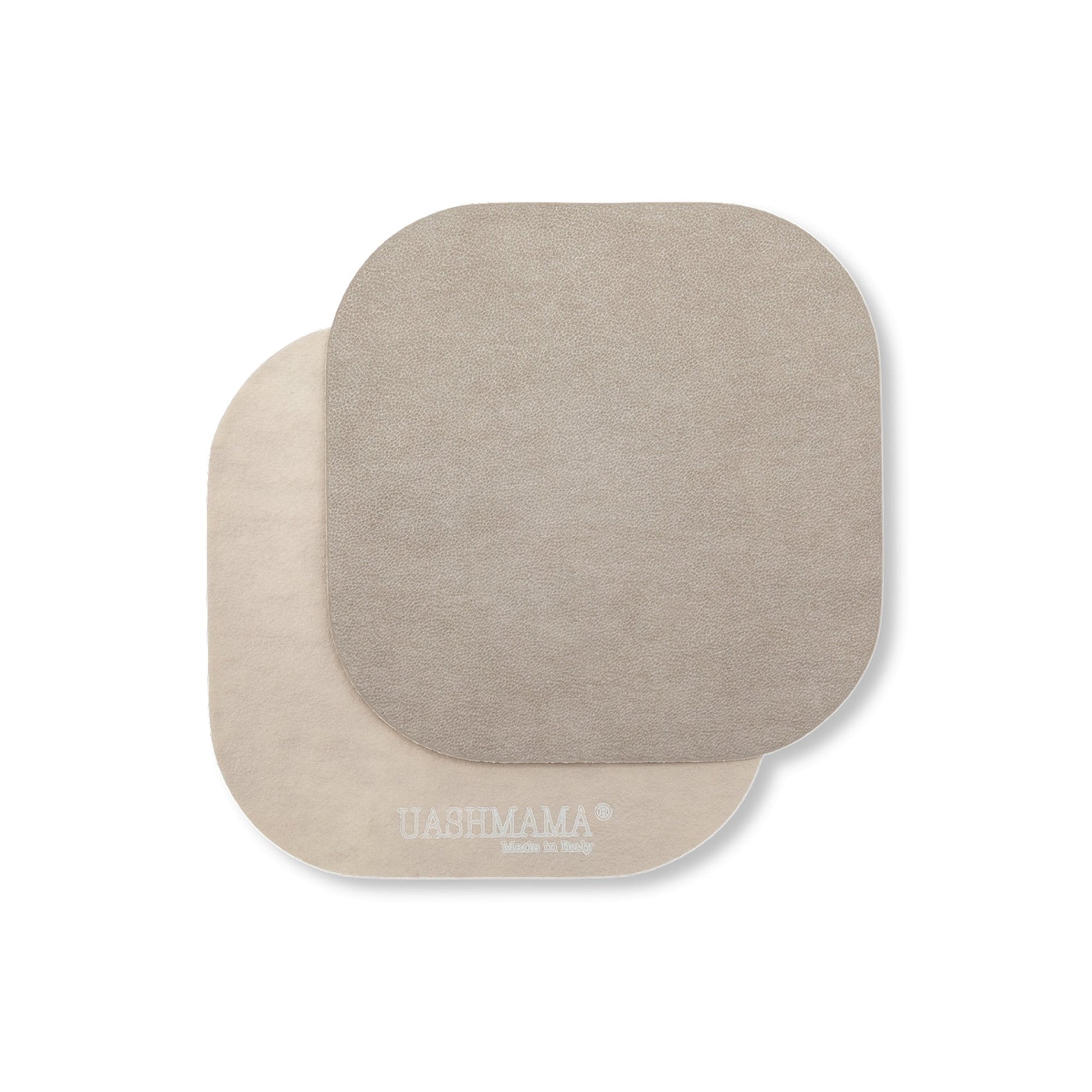 Two rounded edge square washable paper coasters lie one atop the other. The one in the foreground is grey and the one at rear is beige.