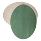 Two oval washable paper placemats are shown on top of each other, at contrasting angles. The one in the rear is beige and the one on top is green.