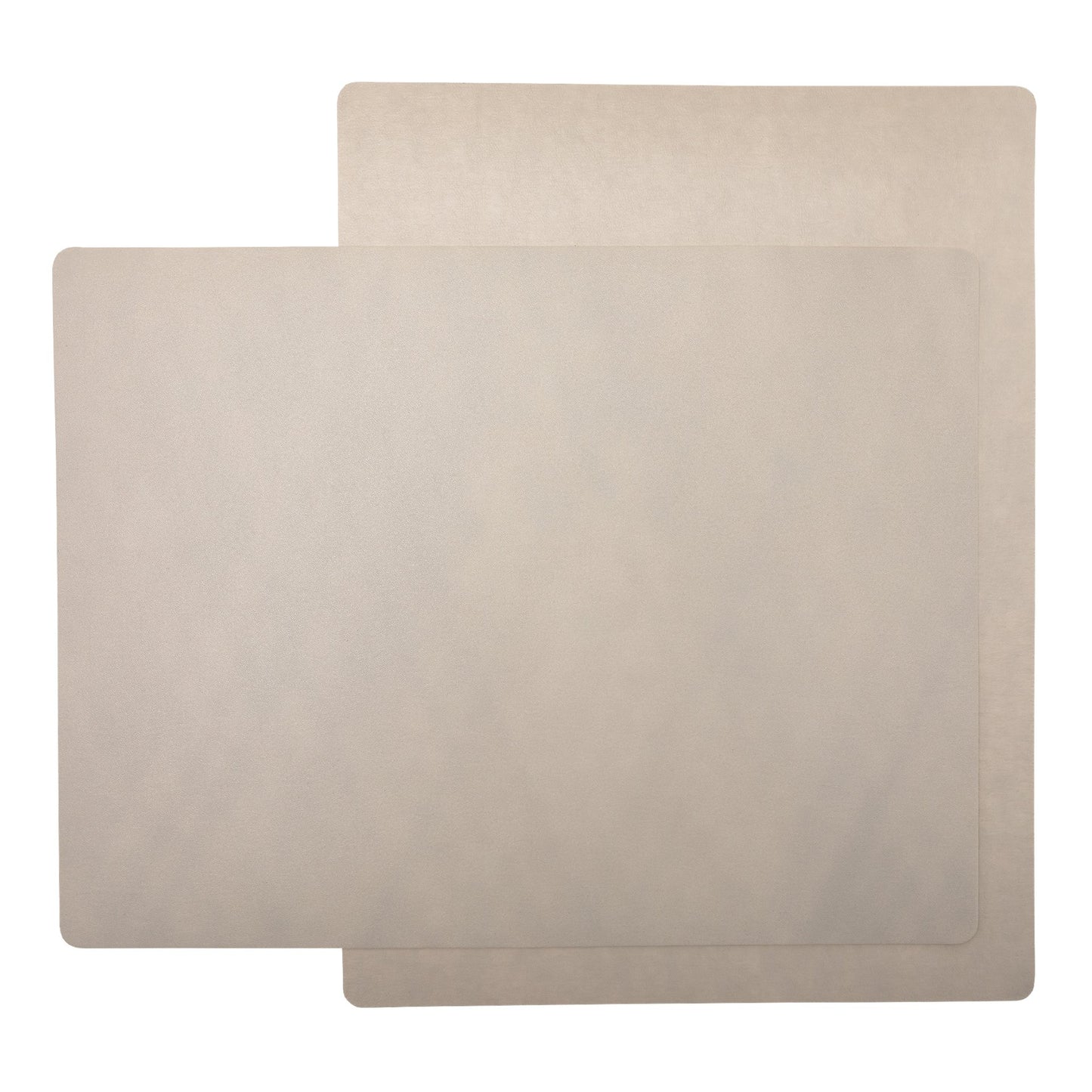 Two rectangular washable paper placemats are stacked one on top of the other, at contrasting angles. They are both beige.