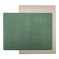 Two rectangular washable paper placemats are stacked one on top of the other, at contrasting angles. The one in the foreground is green and the one at rear is beige.