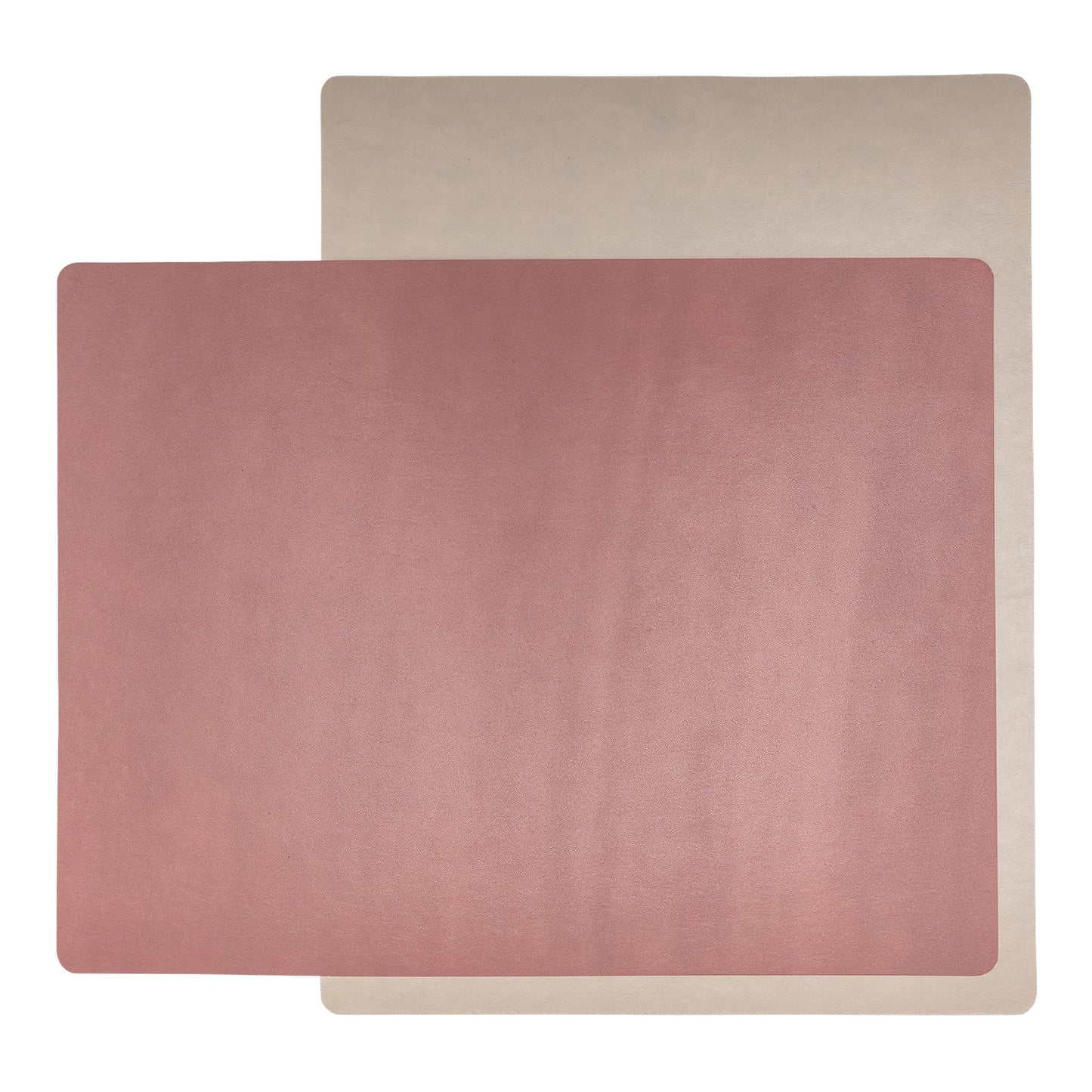 Two rectangular washable paper placemats are stacked one on top of the other. The one in the foreground is pink and the one at rear is beige.