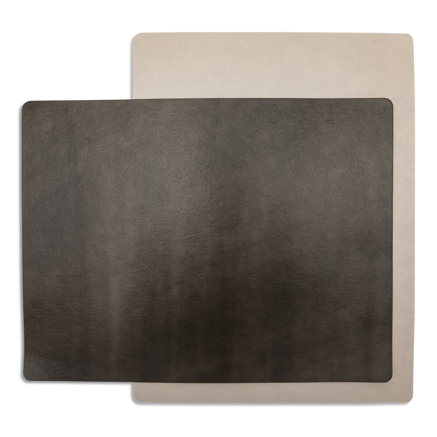 Two rectangular washable paper placemats are stacked one on top of the other. The one in the foreground is chocolate brown and the one at rear is beige.