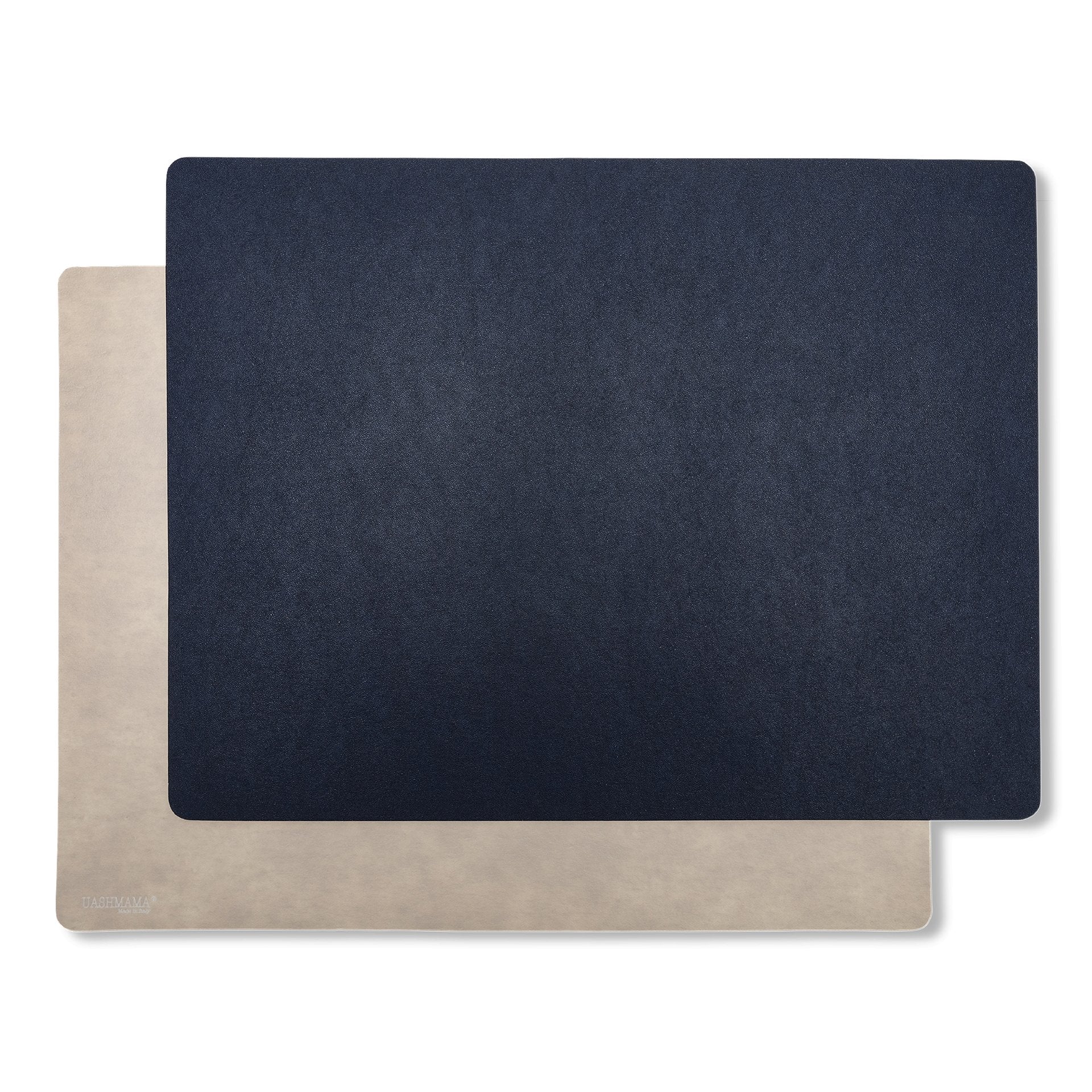 Two rectangular washable paper placemats are stacked one on top of the other. The one in the foreground is navy and the one at rear is beige.