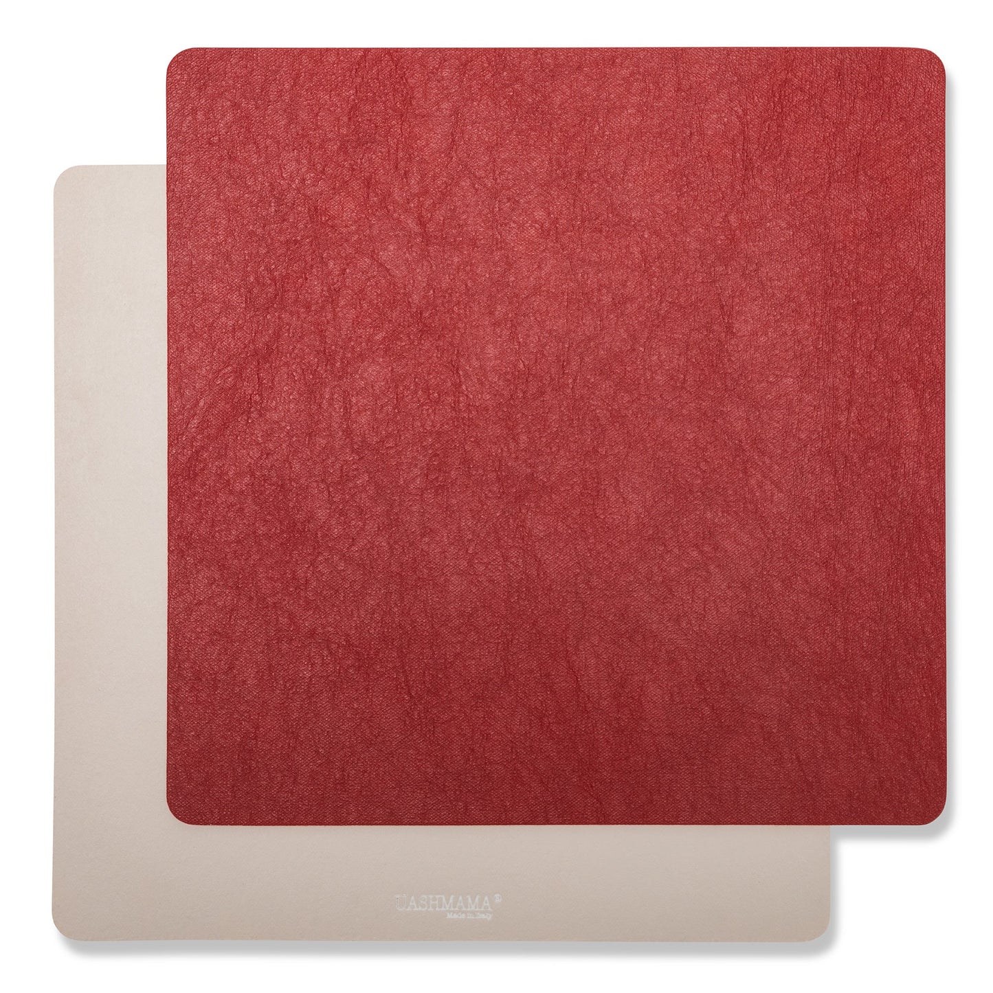 Two square washable paper placemats are shown one on top of the other. The one in the foreground is red and the one at the rear is beige.