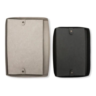 Two washable paper boxes are shown folded flat, from the bottom angle. They feature metallic stud closures to hold them in place. The one on the left is larger and in beige, and the one on the right is black.