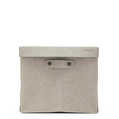 A large washable paper box is shown in grey, with the UASHMAMA logo stamped in the right hand corner of the lid. Two metal studs hold the removable handle in place.