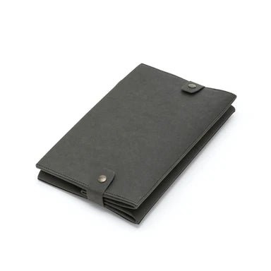A black washable paper box is shown folded flat, with metallic stud closures to hold it in place.