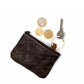 A black washable paper coin purse is shown with three coins at the side. The pouch features an attached keyring at right.