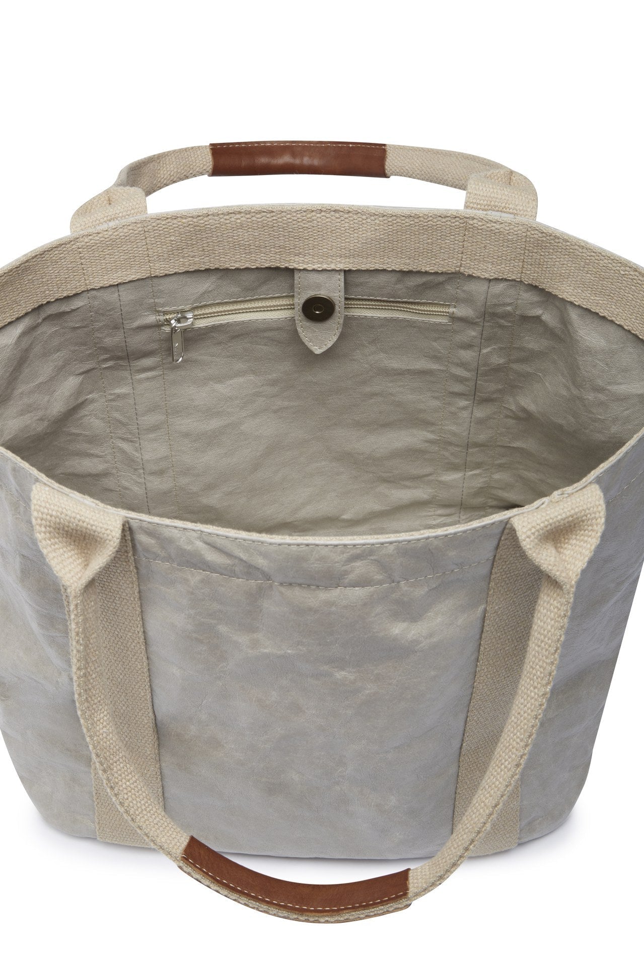 A grey washable paper tote with canvas handles is shown open, from a top angle. It features a popper closure and an inside zip pocket.