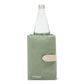 A sage green washable paper cooler is shown with a washable paper side tab with silver stud. It contains a glass water bottle.
