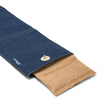 A navy washable paper wine cooler is shown lying flat and open. The freezer insert (brown paper outer) protrudes from one end.