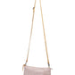 A pale pink washable paper small zip top handbag is shown with a long tan washable paper strap.