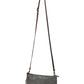 A grey washable paper small zip top handbag is shown with a long brown washable paper strap. 