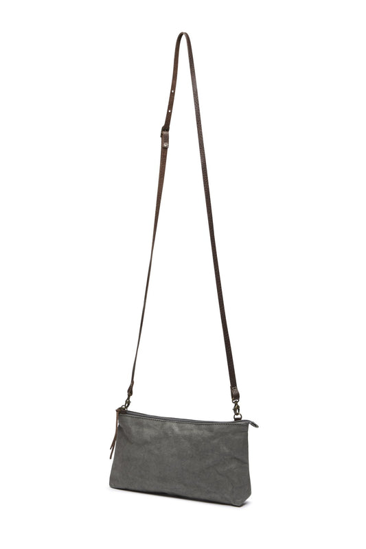 A grey washable paper small zip top handbag is shown with a long brown washable paper strap. 