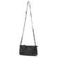 A black metallic washable paper small zip top handbag is shown with a long brown washable paper strap.