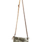 A gold metallic washable paper small zip top handbag is shown with a long brown washable paper strap.