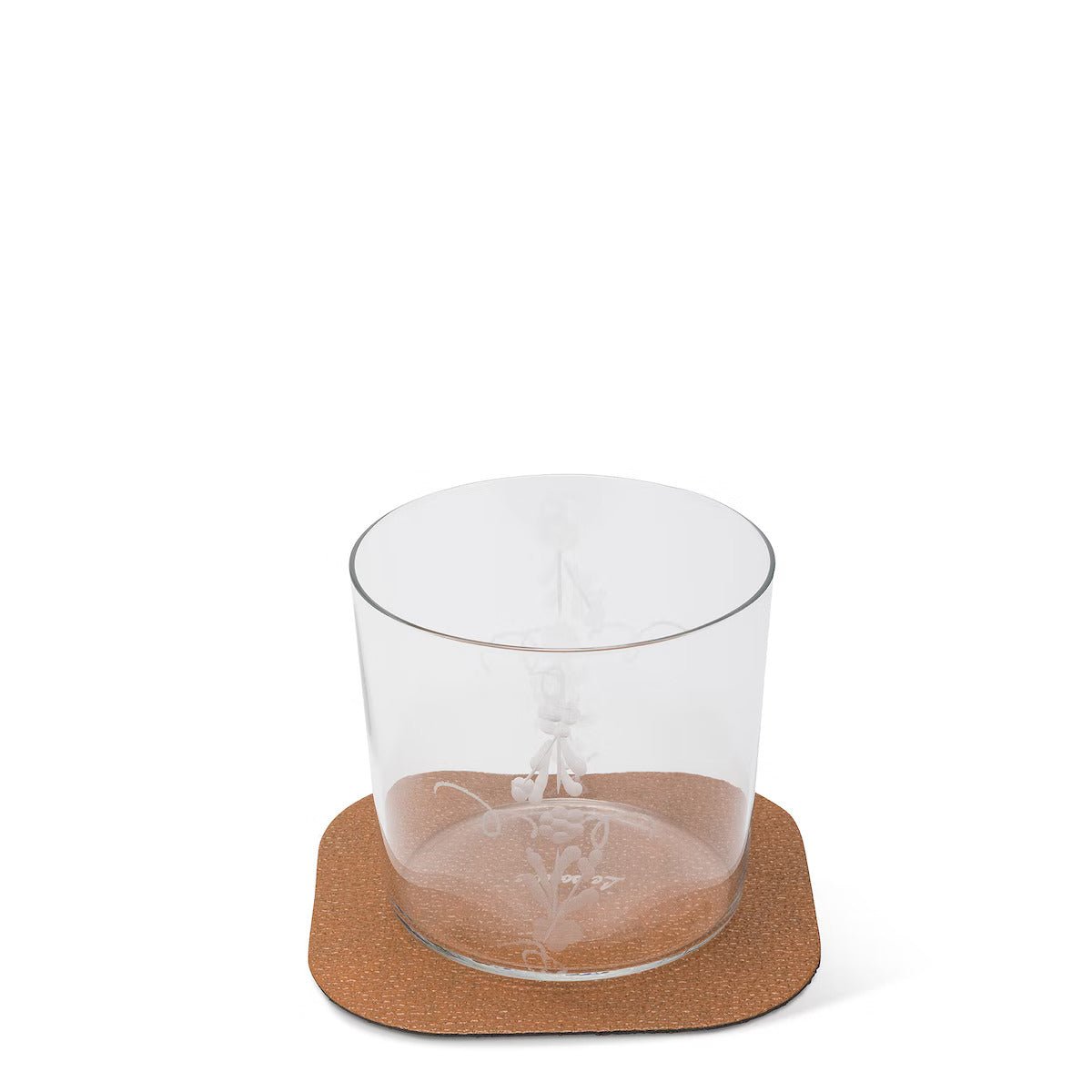 A textured washable paper coaster is shown in tan under a water glass.
