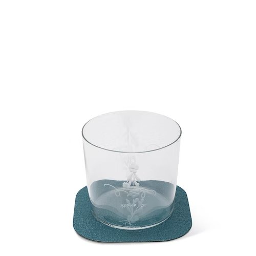 A textured washable paper coaster is shown in teal under a water glass. 
