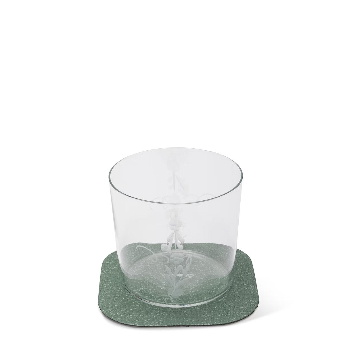 A textured washable paper coaster is shown in green under a water glass.