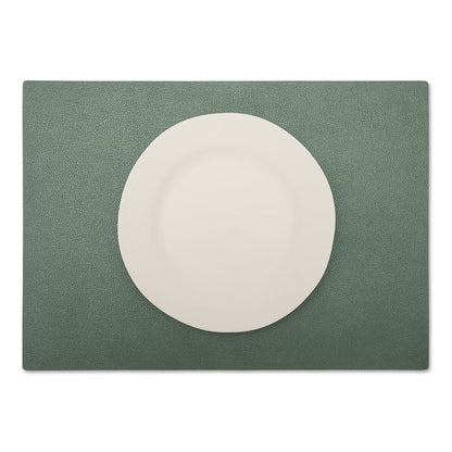 A large rectangular textured washable paper placemat in green is shown under a white plate.