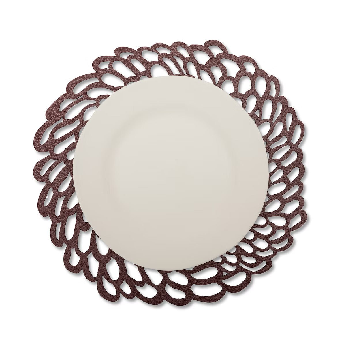 A lace effect washable paper circular placemat is shown in brown, under a white plate.