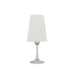 A white washable paper lampshade is shown sitting atop a wine glass.