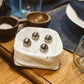 A washable paper tray is shown in white containing four small salt cellars. 