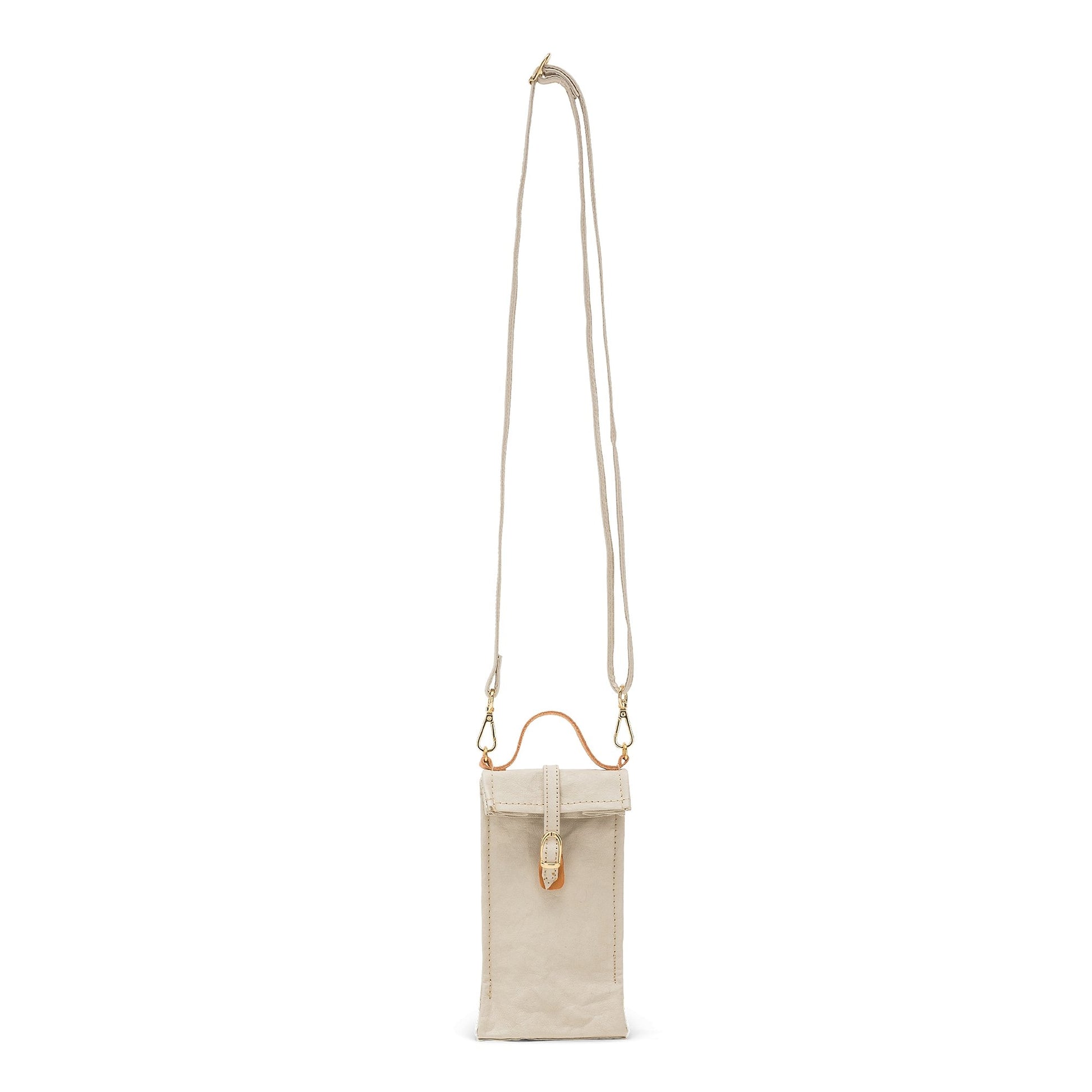 A washable paper phone pouch is shown from the front in cream with a long strap and a brown top handle.