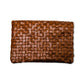 A woven washable paper clutchbag is shown from the front in brown.