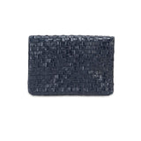 A woven washable paper clutch is shown from the front in navy.