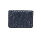 A woven washable paper clutch is shown from the front in navy.