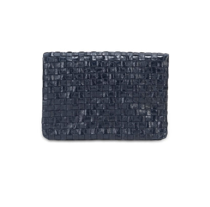 A woven washable paper clutch is shown from the front in navy.