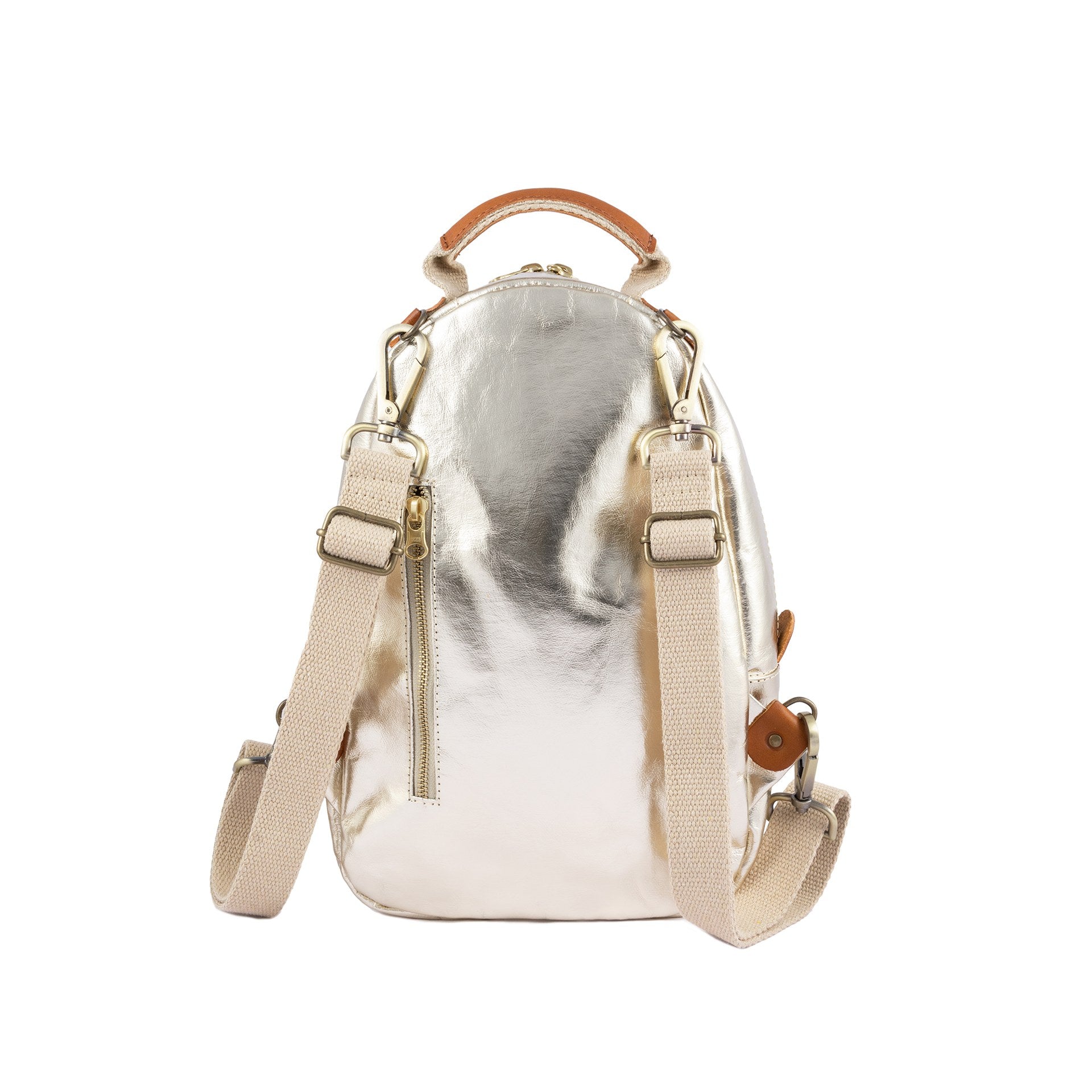 A gold metallic washable paper backpack is shown from a back angle. It features two adjustable cream canvas shoulder straps and a gold zip pocket in the rear.