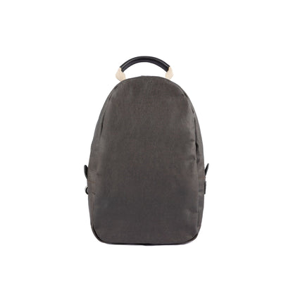 A dark grey washable paper backpack is shown from the front. It features a top zip and a brown and canvas top handle.