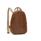 A woven washable paper backpack is shown in brown. It has a rounded shape, a top handle, a side pocket, and two long shoulder straps.