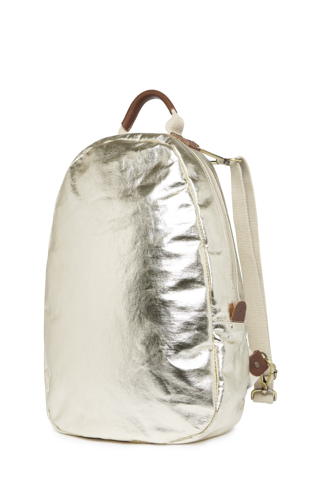 An oval washable paper backpack is shown from a 3/4 angle. It has a top handle, two adjustable canvas shoulder straps, and is metallic gold in colour.