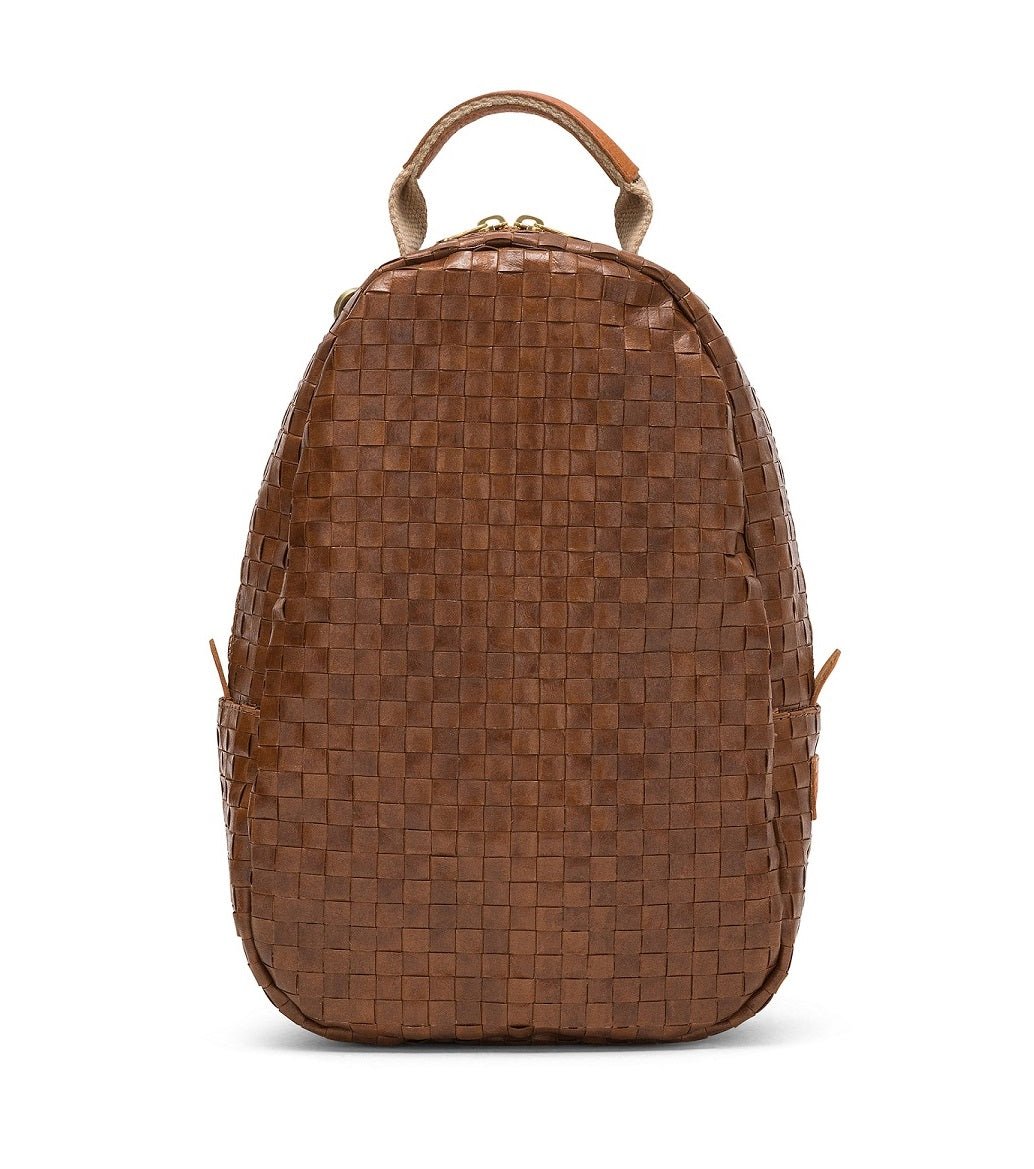 An oval washable paper woven backpack is shown from a front angle. It features a top zip and a top handle. It is brown in colour.