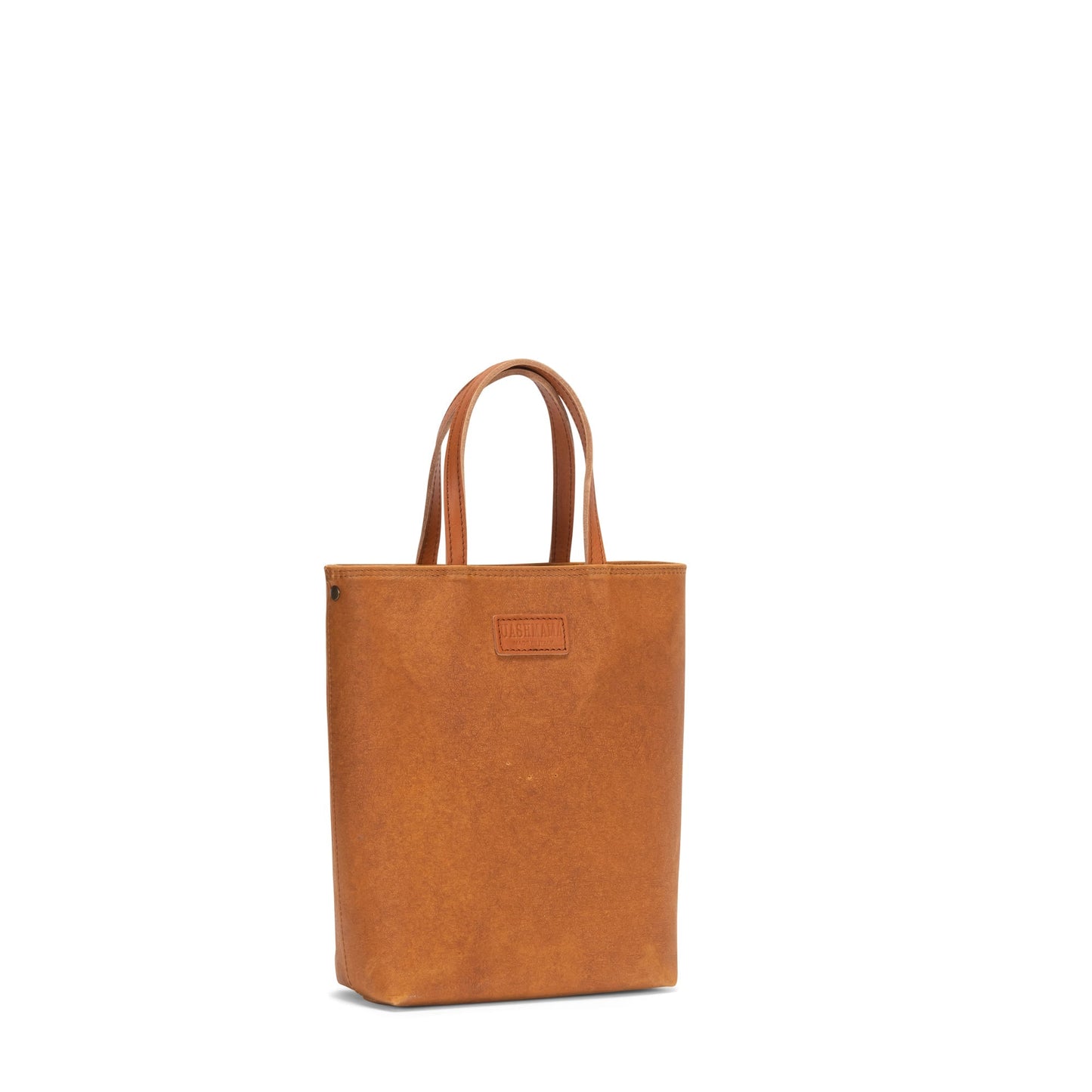 A washable paper tote bag is shown from a 3/4 angle, with the strap removed. It features two long top handles. It is tan in colour.