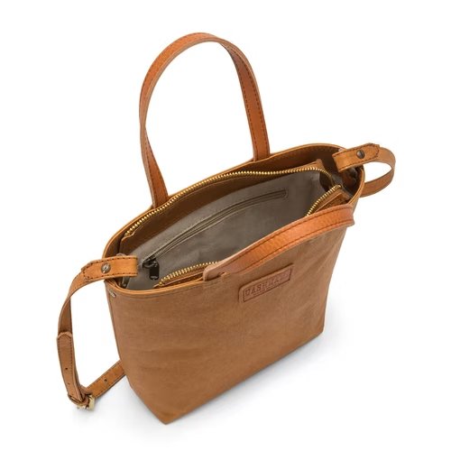 A washable paper tote bag is shown from a top down angle. It features two top handles, a long shoulder strap, a top zip closure and an inside zip pocket. It is tan in colour.