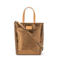 A washable paper rectangular tote with long top handles and a long shoulder strap is shown from the front angle. It is metallic bronze in colour.