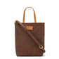 A washable paper rectangular tote with long top handles and a long shoulder strap is shown from the front angle. It is chocolate brown in colour.